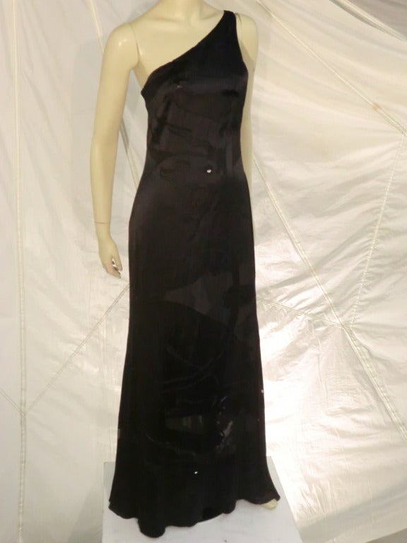 A gorgeous Valentino black silk jacquard gown:  New with tags. One-shoulder construction.  Burn-out jacquard (satin with sheer areas) with a jaguar head motif.  Teardrop shaped rhinestone eyes in three locations.
