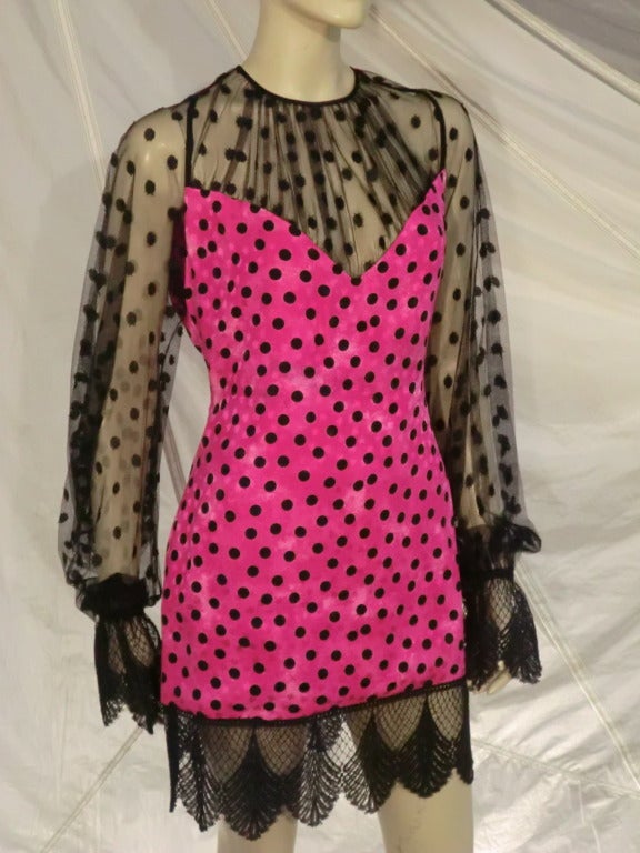 A saucy little 1980s James Galanos mini dress of pink and black polkadot silk jacquard and Swiss dot tulle and lace sleeves and hem.