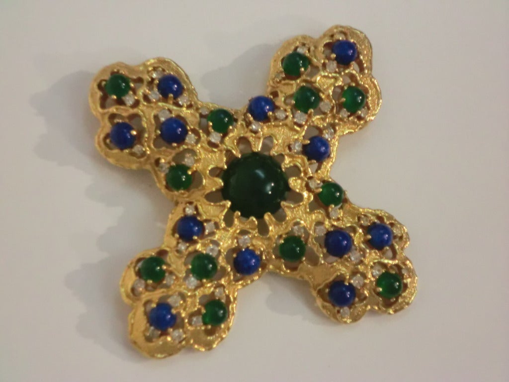 A beautiful, unmarked as to maker, 1970s gold-tone metal filigree Byzantine-style cross with large center glass cabochon and smaller ones throughout in lapis and jade tones. Measures 3.5