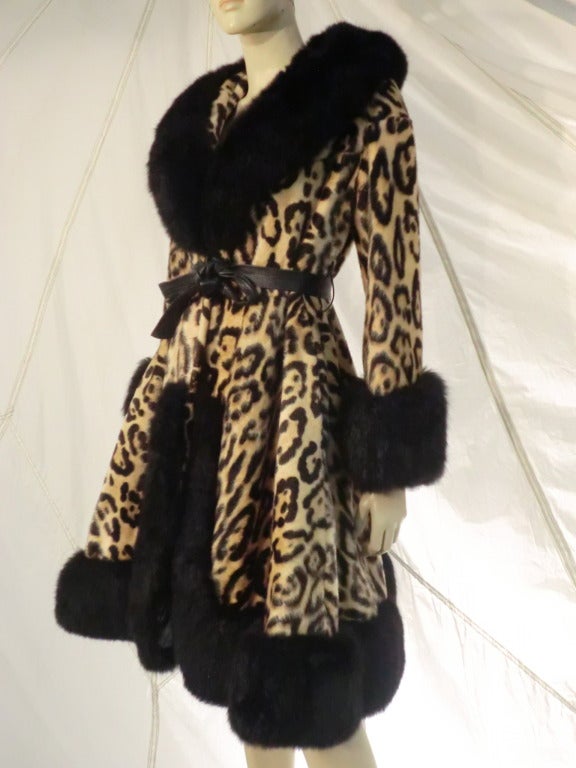 A fabulous 1960s faux leopard print Princess coat with a soft leather tie belt and plush black fox fur trim at collar, cuffs and hem.  Fit and flare waistline.