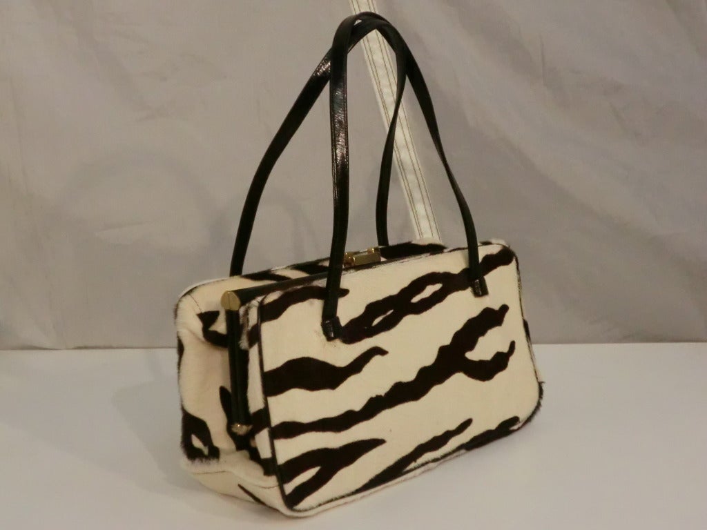 A wonderful 1960s Morris Moskowitz zebra stenciled calfskin handbag with double handles and acetate lined. Strong closure and plenty of room for essentials!