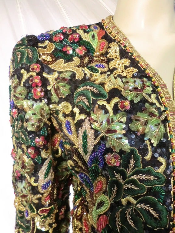 A gorgeous 1983 Oscar de La Renta evening bolero jacket heavily beaded, embroidered and sequined in lavish style!  No front closure--to be worn open.  Padded shoulders.  Long lean strapless black velvet dress with braid and beaded belt and trim