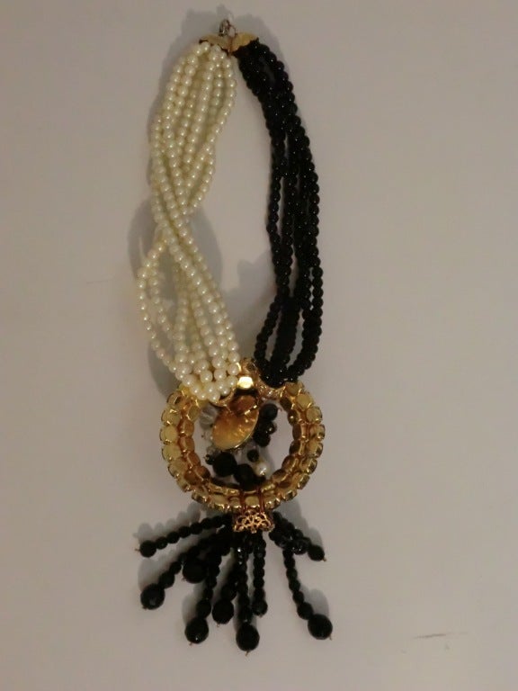 A large statement piece from the 1960s with multiple strands of black and white beads and a rhinestone detailed 