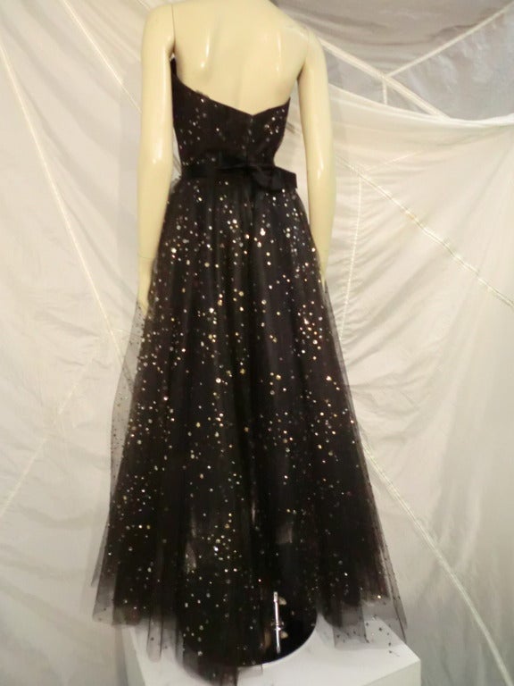 This 1950s ballgown is a fairytale dream! With lesser quality pieces sequins or beads are applied in a continuous string, but this piece is couture quality, meticulously made and decorated with myriad sequins and star shaped paillettes each