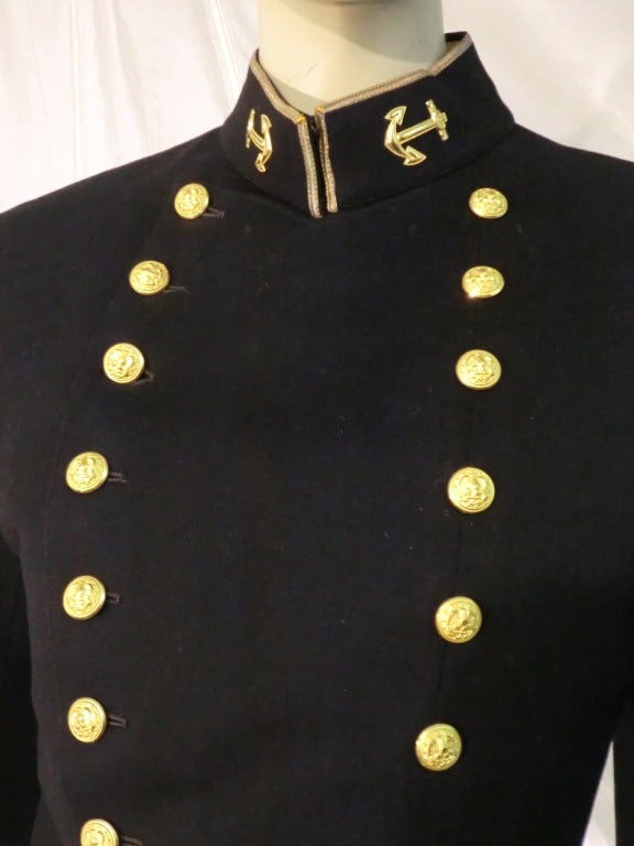 A handsome vintage US Marines dress jacket with rows of gold buttons, cropped waist, band collar and anchor insignia on collar.