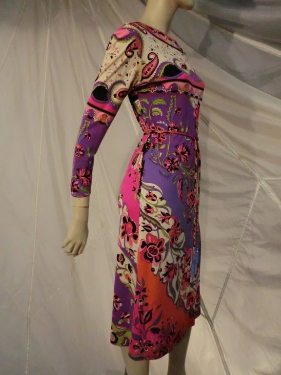 A gorgeous 1960s Emilio Pucci dress:  below knee length silk jersey in paisley and flower pattern.  Long sleeve with back zip and original bead fringed belt.  Some underarm staining.