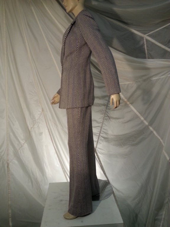 A gorgeous 1990s Randolph Duke black/white herringbone woven wool pants suit with single button, wide notched lapel blazer and flat front, flared leg trousers.  Lined in trellis pattern black/white silk.