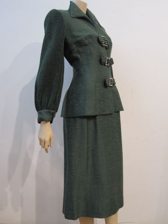 A fantastic early Lilli Ann 40s suit in a gorgeous holiday green silk, with extravagantly micro-pleated and cuffed sleeves, rhinestone embellished bow closures and pure 40s style!
