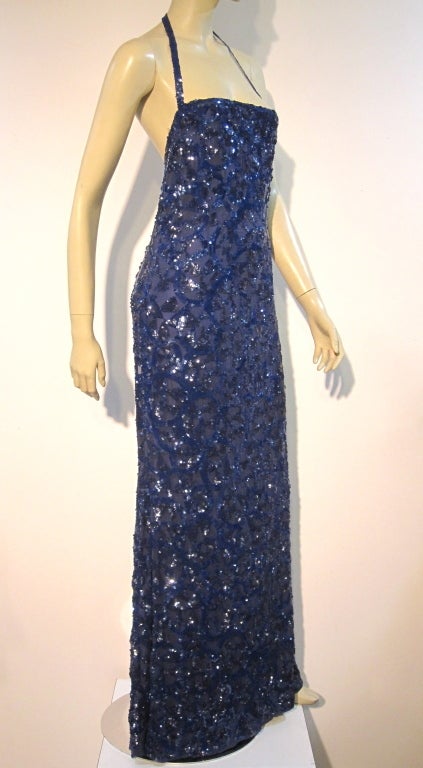An exquisite, unmarked, but typical of French quality of the period, crepe gown with Art Deco patterned, cobalt blue, sequins throughout. Halter neck with tie and low back with fishtail hem. Size 4-6.