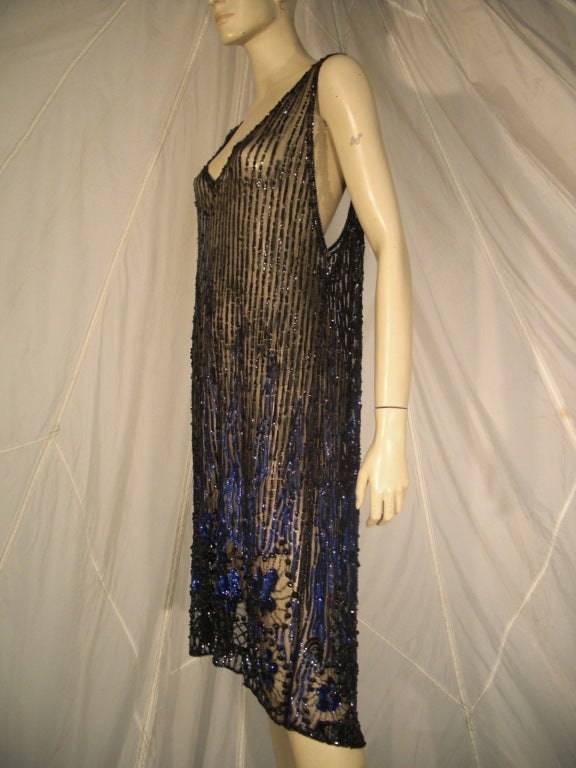 A sexy 1920s beaded and sequined silk tulle over-dress: just below the knee with a deep slit at side and deeply cut arm holes.  Be as daring as you like!