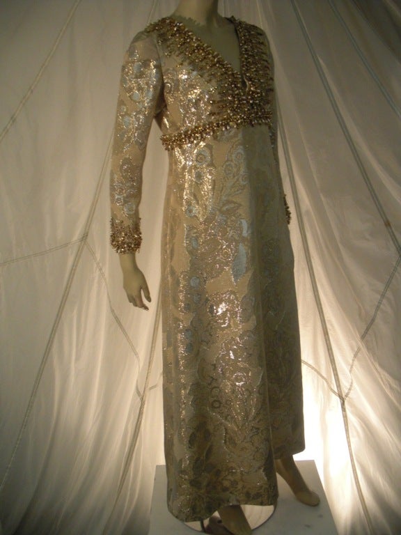 A metallic Marty Modell brocade mod 60s empire waist dress sold at I. Magnin.  Heavily beaded around the neckline, Empire waist and cuffs.  Zippered back.