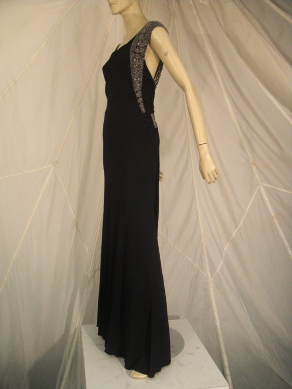 A beautiful 1930s black crepe and beaded evening gown:  bias cut, long and lean, this piece has a wonderful beaded shoulder band design that wraps around the back to form a low crossing bead work band. This gown has been attributed to Jean Patou by