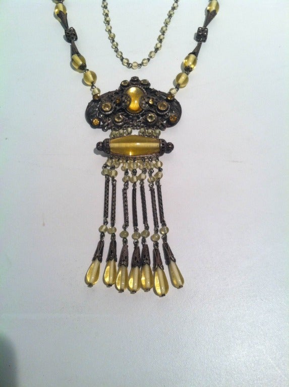 A gorgeous 1920s citrine yellow glass bead and brass filigree necklace with bead and chain fringed center piece.  32