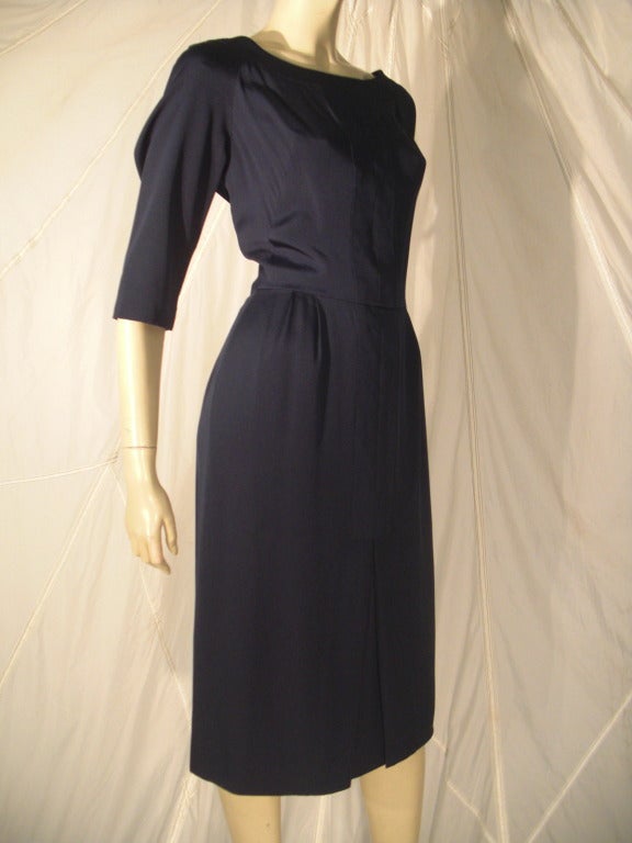 A gorgeously simple and stunningly tailored 1950s Helen Rose navy blue silk charmeuse day dress:  subdued detailing with inset panels, ballet neckline and center front box pleat. Back zipper.  A stunner.