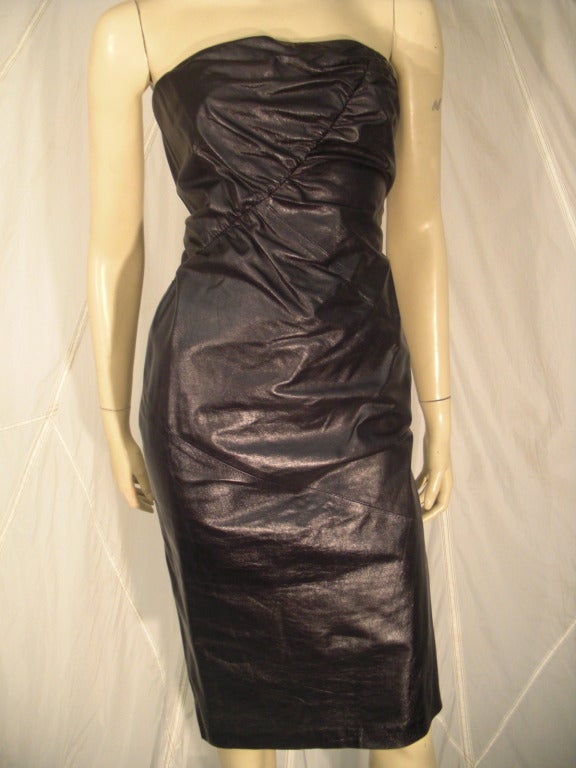 A never-been-worn 1990s Gucci leather strapless dress with diagonal ruching and back slit.