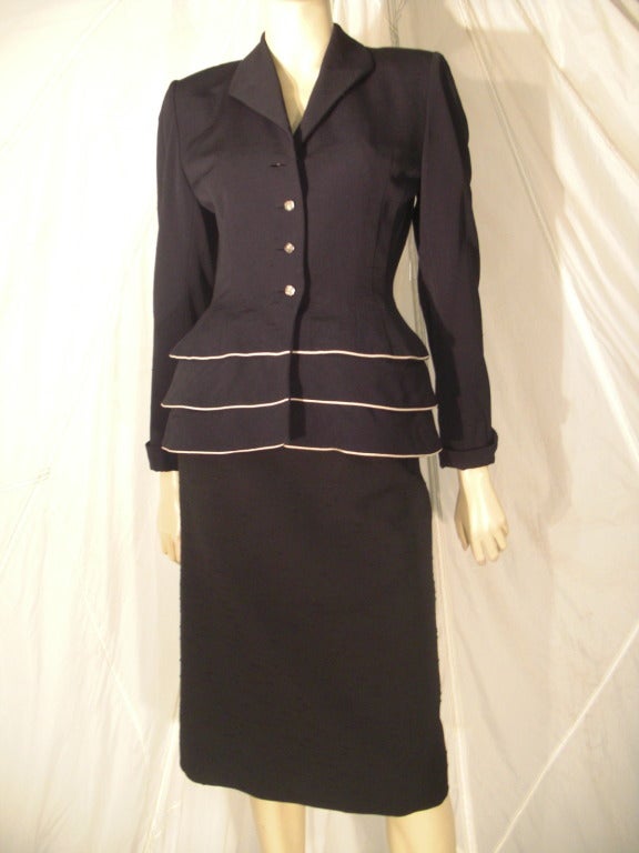 black suit with white piping