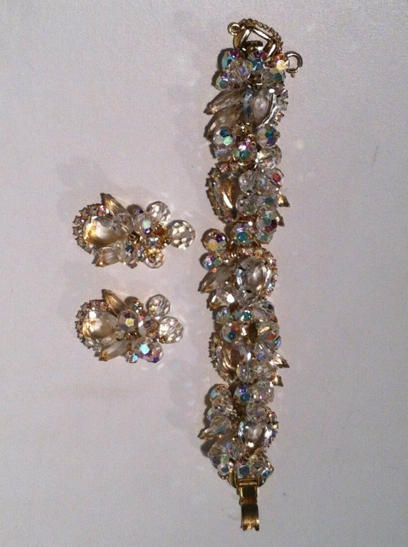 A gorgeous late 1950s Julianna aurora borealis rhinestone and bead bracelet and earring set:  Bracelet is characteristically built on the 5 link Julianna trademark backing with chunky rhinestones and moving beads in a goldtone prong setting.  Safety