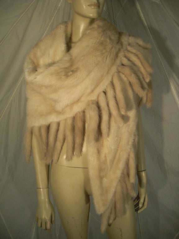 A 1980s Revillon honey color mink wrap: An isosceles triangular shape, silk lined, and edged on two sides with mink tails.  Originally sold at Saks Fifth Avenue.  29