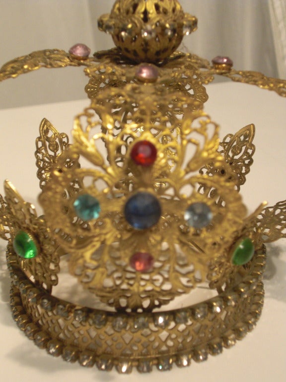 A fabulous miniature (5 in. tall) crown, originally meant for statuary:  Gold toned metal filigree and glass jewels. Would be amazing for a child's costume!