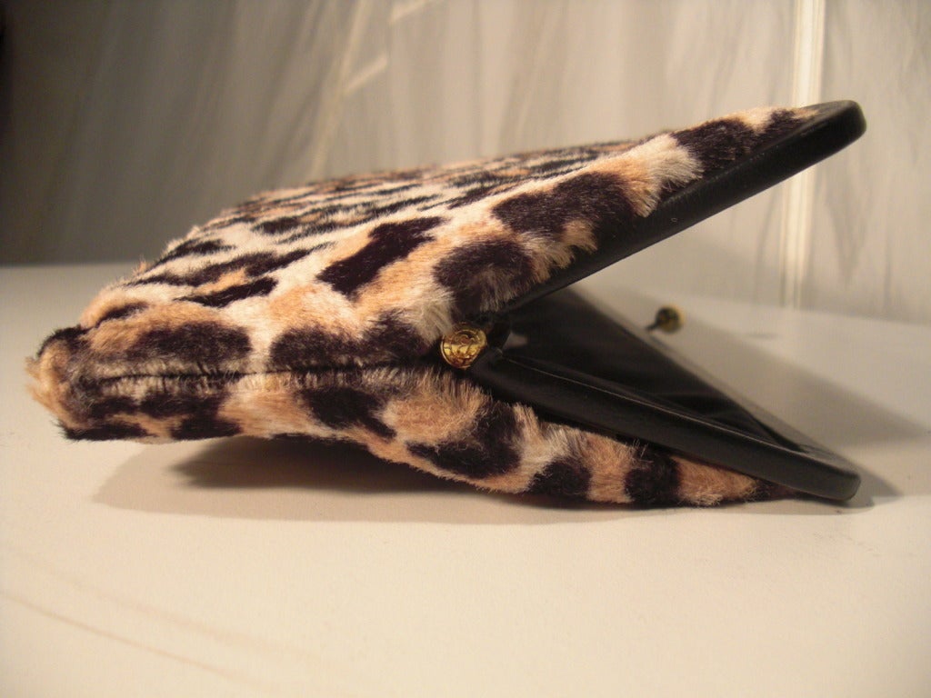 A gorgeous 1950s Ingber faux leopard fur clutch with black faille lining and leather piped frame.  Kiss clasp closure.