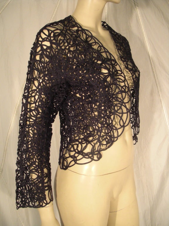 A fabulous 1980s Thierry Mugler rayon soutache  lace bolero jacket made from leather piping stitched together in a freeform fashion.  Unlined. No closures.