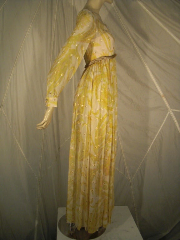 A beautiful 1970s Malcolm Starr organza "Bollywood" style maxi dress in yellow print with gold stars.  A wrap-style bodice with sheer cuffed sleeves, gold bullion braid belt and gathered full skirt.  Fully lined.