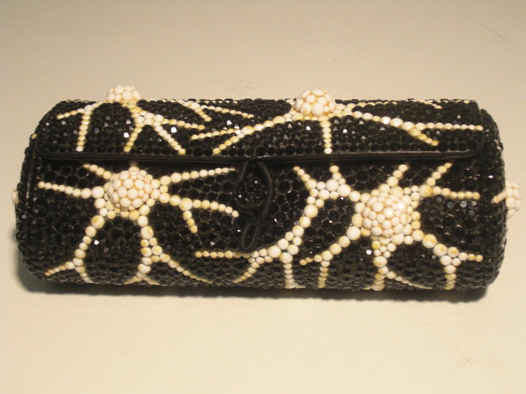 A gorgeous 1960s Koret black and white crystal encrusted 3-dimensional coral patterned evening minaudière with leather lining and button/loop closure.