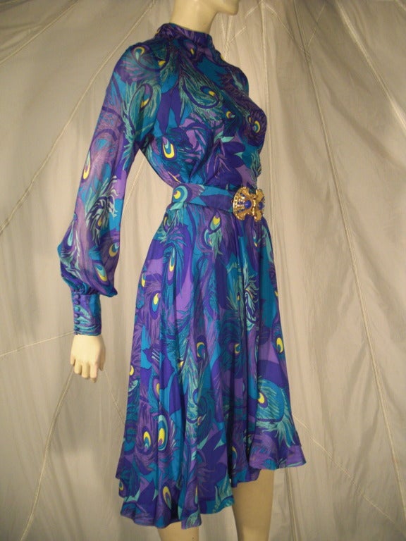 A fabulous 1970s La Mendola silk jersey and chiffon abstract peacock print cocktail dress with sheer balloon sleeves and button cuffs.  Matching original belt with gold-tone buckle included.