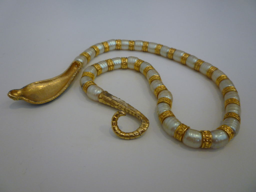 This is a gorgeous Egyptian Revival style unmarked Hattie Carnegie necklace in brightly enameled gold-tone metal and faux pearls.  Great design with the tail wrapping around the neck to close!