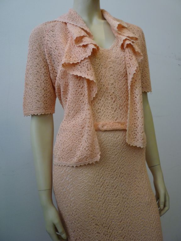 Beat the summer heat in this peachy 1930s crochet gown and jacket!  Beautiful back details and a ruffled jacket make this a beautiful option for a summer soiré!  Belted at the waist with a keyhole cutout at the back!