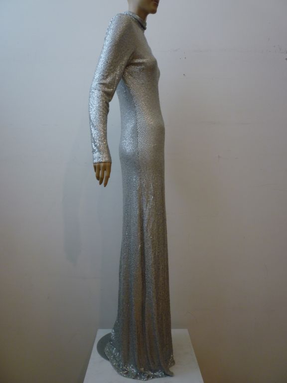 Spectacular Michael Kors liquid silver long sleeve turtle neck sequin gown in matte sequins on silk jersey.  Invisible zippered back. A beautiful reinterpretation of Norell's Mermaid style!  Marked a size 12.