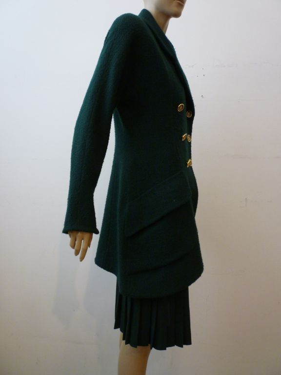 Karl Lagerfeld late 80s asymmetrical jacket in forest green wool bouclé with military style double breasted metal and enameled  monogram buttons.  Includes wool gabardine knife pleated skirt that previous owner had custom made to wear with this