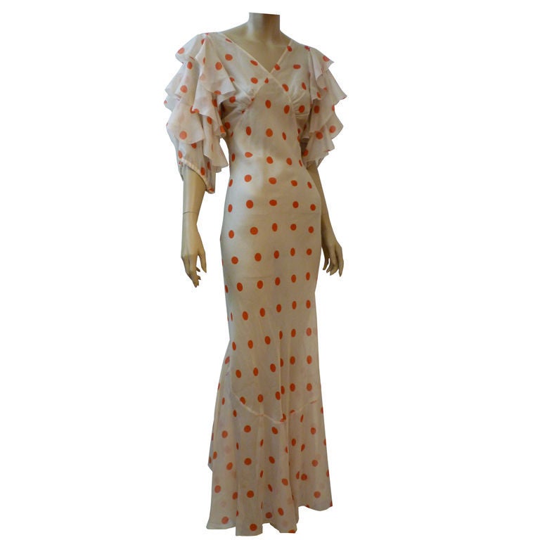 Wonderful 1930s red/white polka-dot chiffon bias cut gown has full ruffled sleeves and a back tier of ruffles from waist to hem.  Flirty and whimsical.