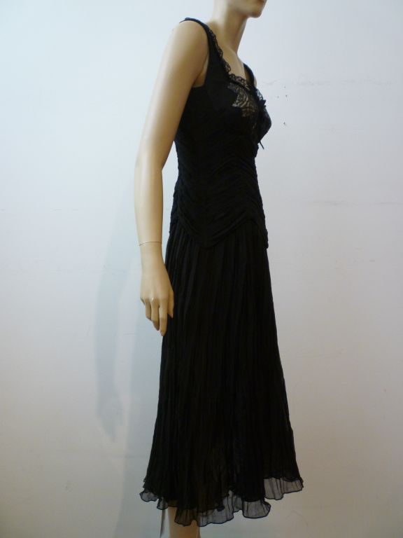 This is a beautiful and sexy dress from Alexander McQueen with a ruched silk chiffon bustier-style bodice that features lingerie lace insets (center lace inset is completely sheer)and a pleated chiffon skirt.  Marked a European size 44.