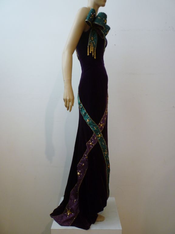 This coronation-worthy Bob Mackie gala gown in purple silk velvet with regal jeweled satin sashes was featured in Vogue Magazine in the 80s and is still absolutely stunning!  Marked a US size 6.