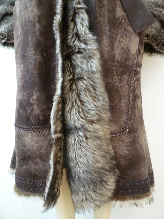 Fantastic Roberto Cavalli men's shearling coat treated and dyed to look like exotic pelts!  Decorative rustic stitching, fur lined hood, deep cuffs and wool belt tie combine great style and wonderful detailing! Marked an XL.