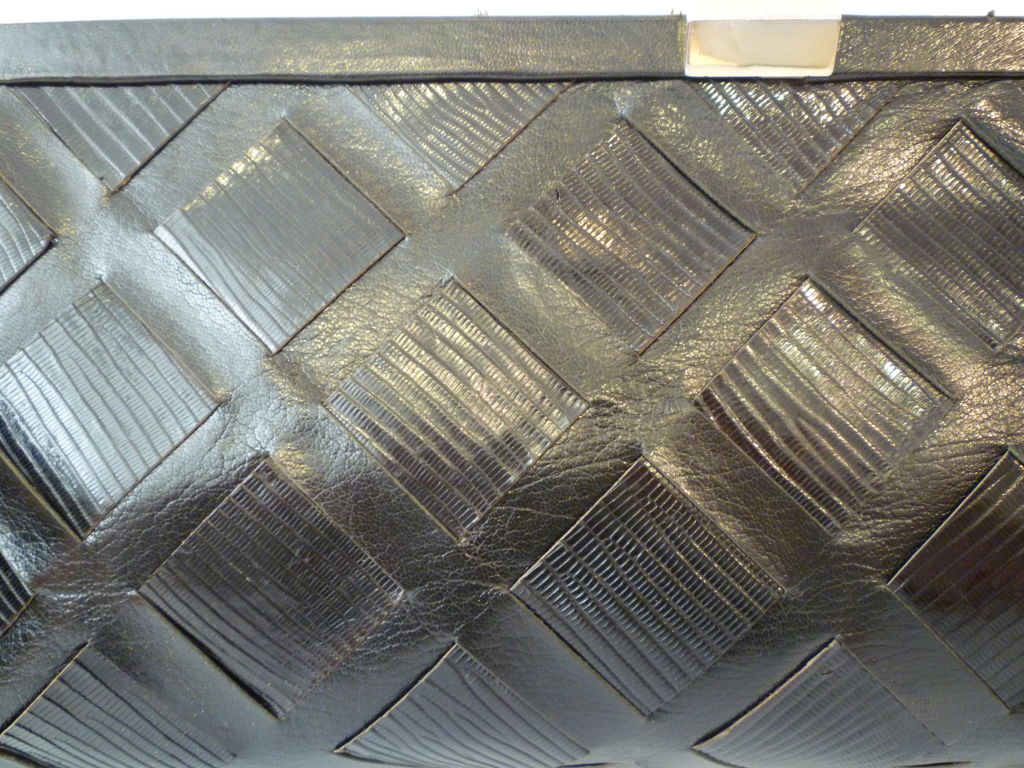 Gorgeous 1970s Edoardo Giannotti woven leather clutch with heavy gold plated clasp and corner pieces and original maker plaque inside.  Interior has one zippered pocket and exterior is woven with lizard and leather.