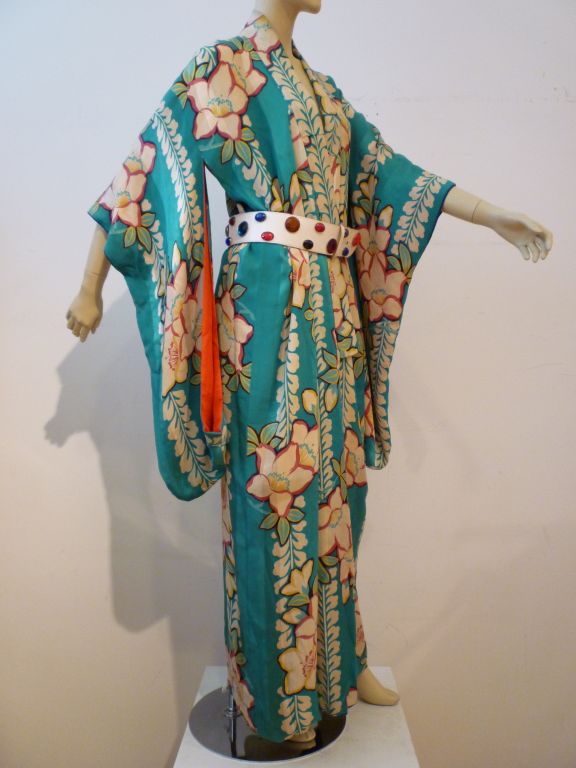 This kimono is really extraordinary!  Vibrant turquoise background and large floral print on a background satin/matte stripe weave.  Inside is lined in a stunning combination of red and cobalt blue!