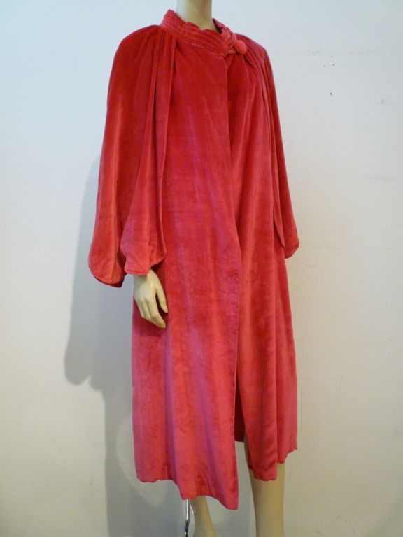 This is an exquisite 1920s piece for evening!  Fuchsia silk velvet calf-length jacket with scallop edged capelet and button/loop neck closure. Matching fuchsia lining.