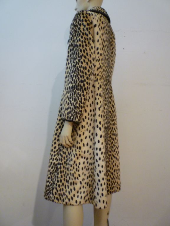 Safari from Sportowne!  60s mod long faux cheetah double breasted coat trimmed in real leather.  Gorgeous!