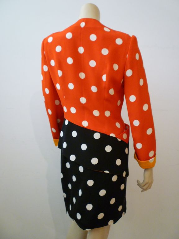 Vivacious 1980s Geoffrey Beene multicolor polka dot suit.  Asymmetrical hem on the jacket and contrasting colors on the turned back cuffs and neckline provide endless interest on this wonderful example of Beene's whimsical side.