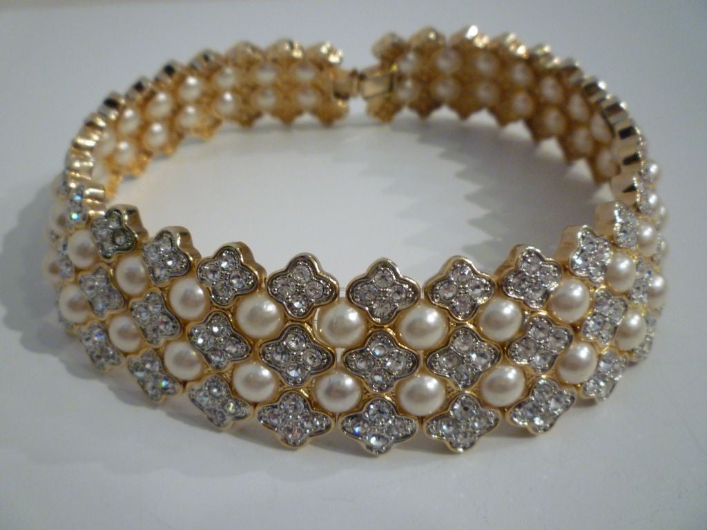 A chunky statement piece from the 1980s!  An unmarked flexible rhinestone and faux pearl piece. Wear it with a simple dress for drop-dead chic!<br />
<br />
Dimensions: <br />
15.5
