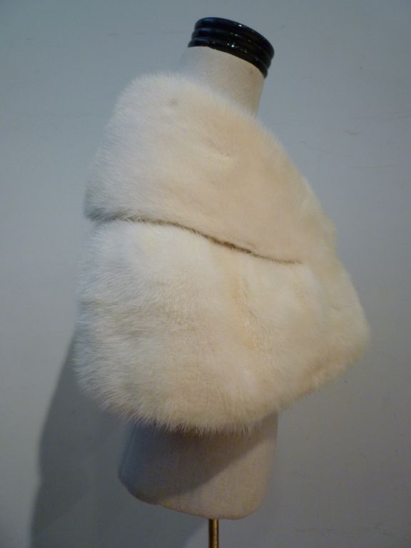 The perfect accessory for the holidays!  A 1950s-60s white mink stole from Saks Fifth Avenue lined in silk with a button closure for hands free style!<br />
<br />
Dimensions: <br />
42