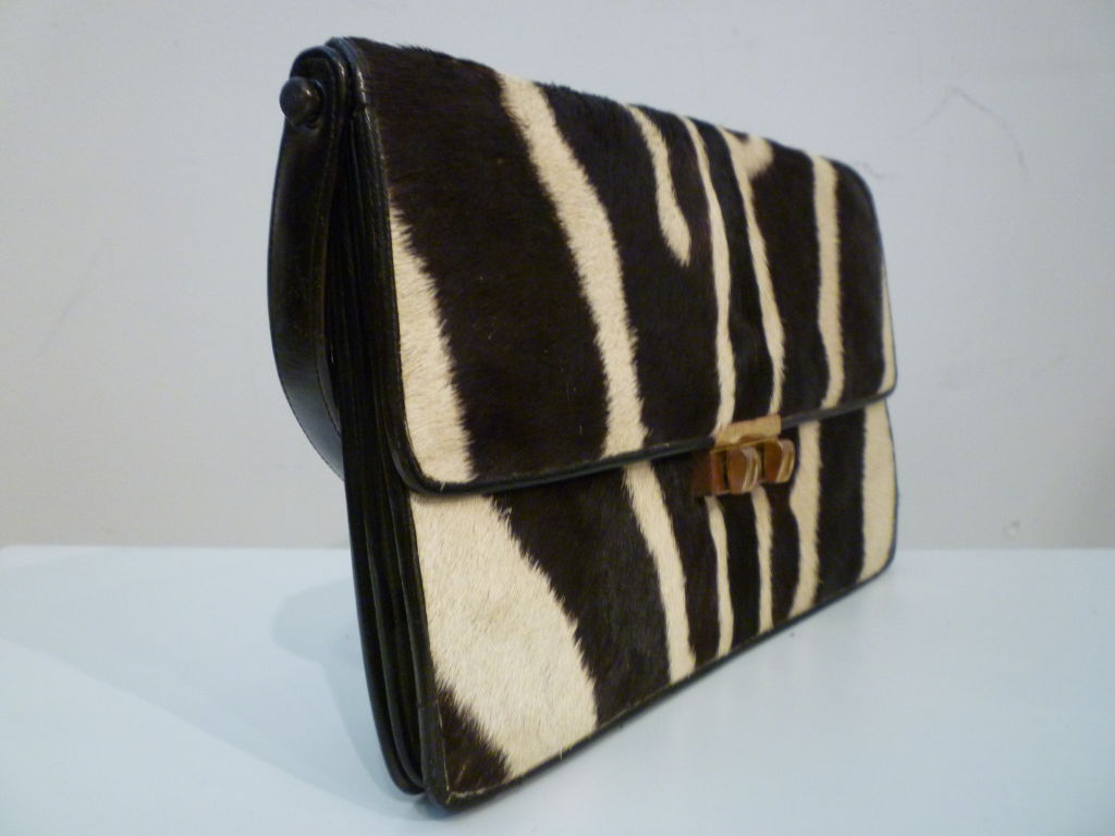 A smart and sturdy 60s purse fashioned in Kenya East Africa from genuine zebra in a sleek accordion style with multiple pockets. Very strong handle and workmanship!  <br />
<br />
Measures 13