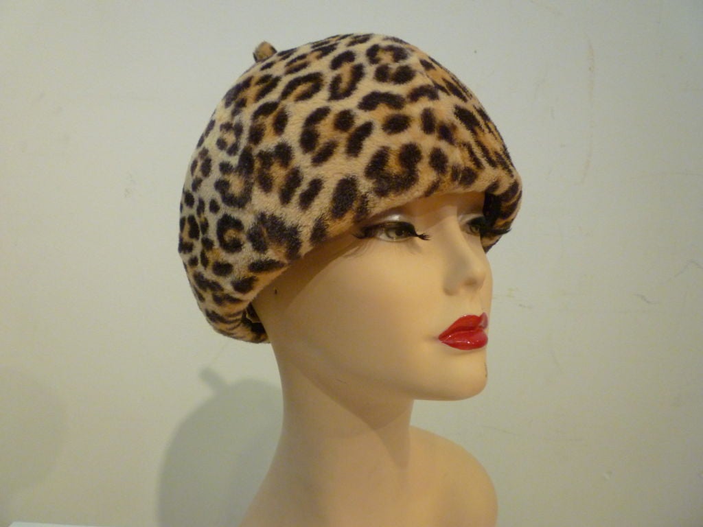 THis is a fantastic 60s mod Mr. John beanie/beret style faux leopard fur hat: super structured with a small stem at the top center. A wonderfully stylish hat from a primo maker!  Inner band measures 21.5