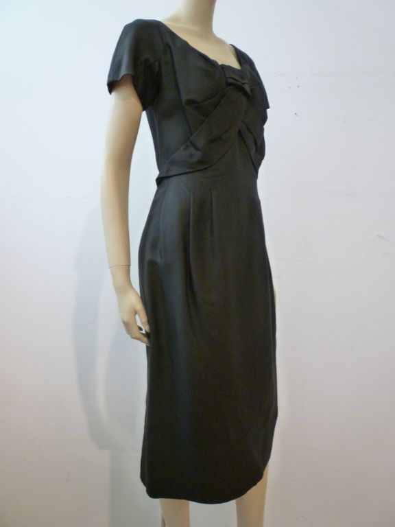 This is a wonderful early 60s era Christian Dior dress in black silk with wonderful bodice detail!  Perfect for your Mad Men party!