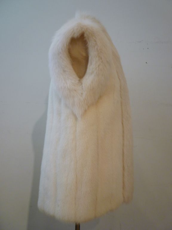 A fantastic winter white Oscar De la Renta vest: reversible with leather on one side and mink with fox trim on the other!  Original tag is included (not attached because it is reversible!)<br />
<br />
Adjustable leather drawstring waist on