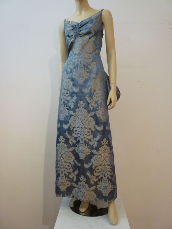 A supremely elegant 1930s gown, made of high quality brocade with metalic threads by a seamstress (no maker tag).  Typical unlined 1930s construction with a ruched decolletage, low V back and extravagant bustle and train in back. This piece is