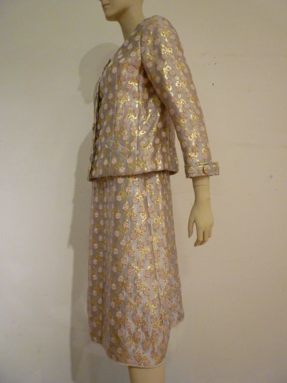 A spectacular 1960s Christian Dior Boutique numbered piece in exquisite silk and metal floral brocade! Approx. size 6-8 US.  Under dress is made with a silk tank style bodice to go under the lined jacket.  Jacket features heavy faux button, snapping