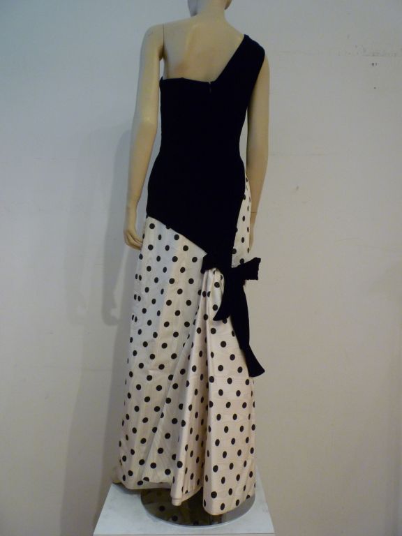 A fabulous asymmetrically styled gown from the early 80s with one-shoulder and back bow.  Made from black silk velvet and black/white silk polka-dot taffeta.  Marked US size 10.